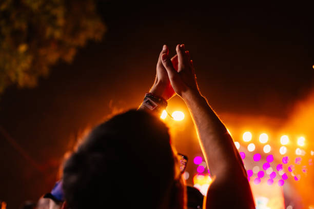 istock Raised hands at music festival. 1498454105