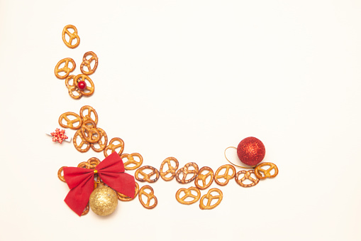 Pretzels and Christmas decorations on a white background. Christmas and New Year's mood. Copy space.