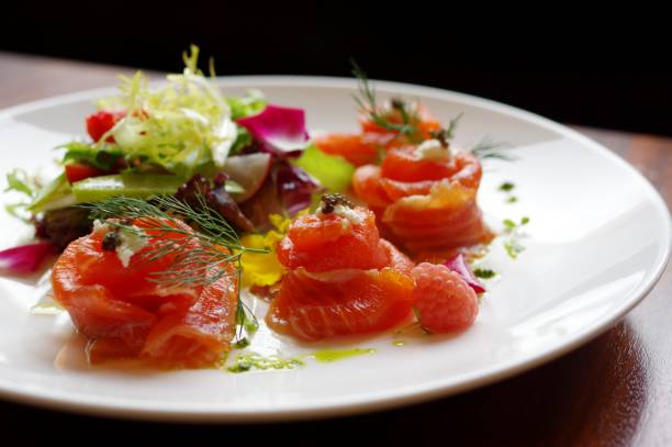 istock Raw salmon sashimi roll salad with caviar and cream 1498454347