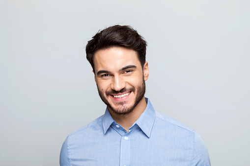 Half-faced portrait of serious concentrated confident brutal chic handsome attractive classy modern guy wearing classic white shirt suspenders isolated on gray background copyspace empty blank