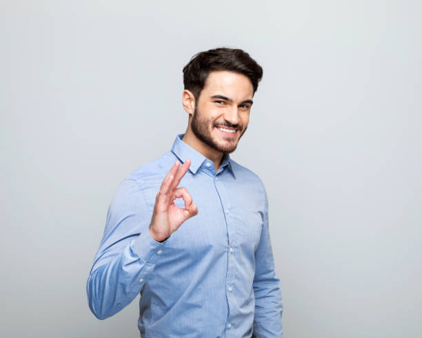 Young businessman showing ok sign
