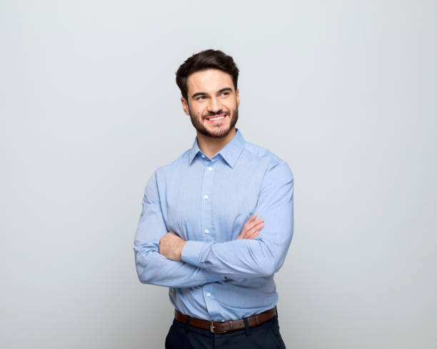 istock Young businessman standing with arms crossed 1498457290