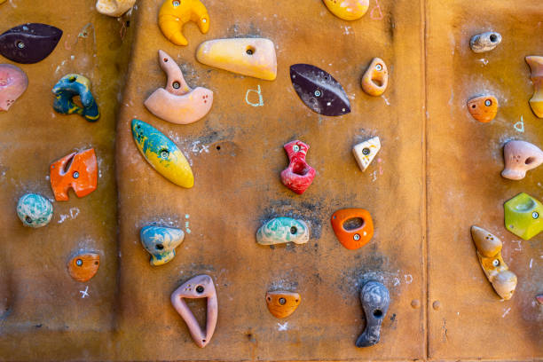 istock Brown wall with climbing holds outside 1498457568