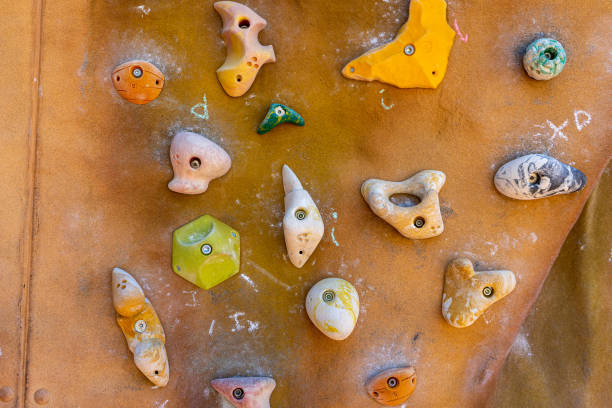 istock Brown wall with climbing holds outside 1498457569