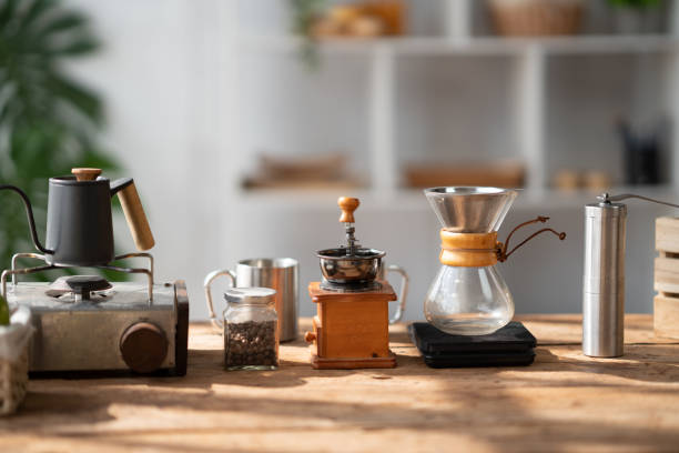 istock Coffee making concept, Old coffee grinder, manual hand mill on the table with coffee pot and coffee cup. 1498458090
