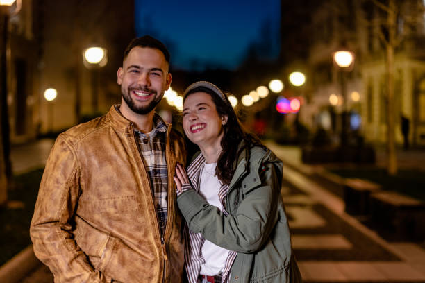istock Young Couple Enjoying Conversation on Evening Walk 1498458994