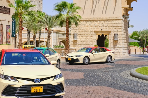 Dubai,UAE,Aug.2022:Dubai municipal urban taxi next to Souk Madinat Jumeirah, popular tourist landmark