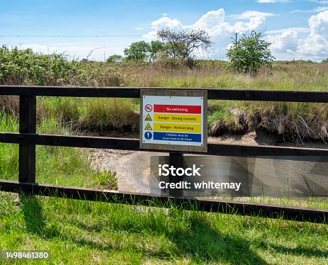 istock Safety barrier with warning sign in marshland 1498461380