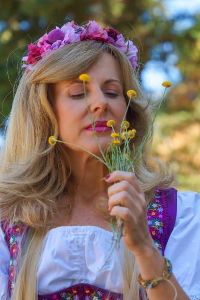 istock A beautiful woman smells some small spring flowers 1498462168