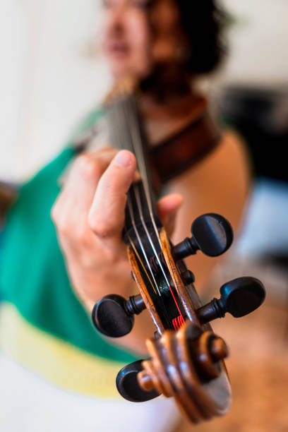 istock Dedicated Study: Professional Violinist Immersed in Home Practice Session 1498464152