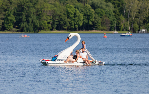 Bad Saarow, Germany - June 4, 2023, driving with the family in the swan boat on the lake in the best weather copy space.