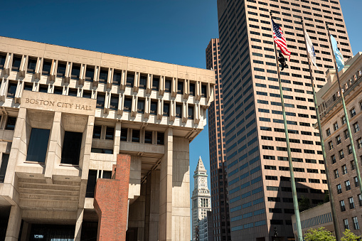 Boston, Massachusetts, USA – July 19, 2022:  exterior view of the Boston City Hall and downtown skyscraper office buildings of the financial district in Massachusetts USA