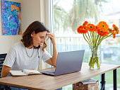 woman using laptop while working indoors