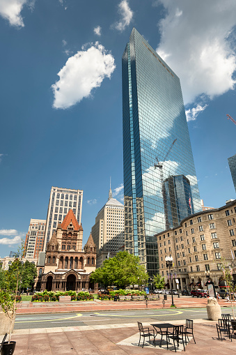 Boston, Massachusetts, USA – July 20, 2022:  Buildings rise over downtown Copley Square named for painter John Singleton Copley, is a public square in Boston's Back Bay neighbourhood what is the sine of Trinity Church and the Boston Central library