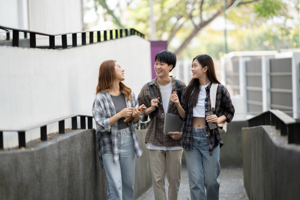 istock Cheerful college students having the conversation before the classroom starts. Friendship, Education concept. 1498466376