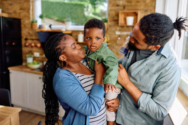 istock Small black boy and his parents enjoying at home. 1498468002