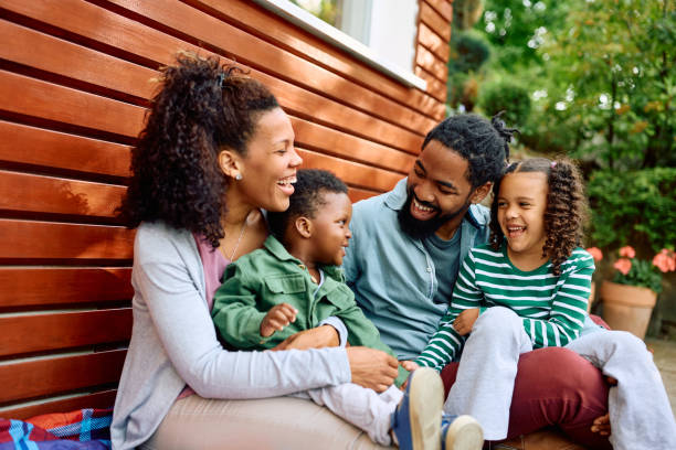 istock Happy black parents and their kids talking while relaxing in the backyard. 1498468107