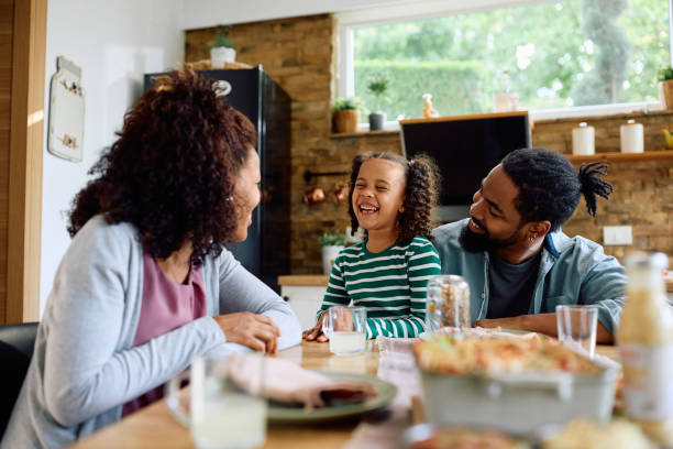 istock Cheerful black family talking while having a meal at dining table. 1498468147