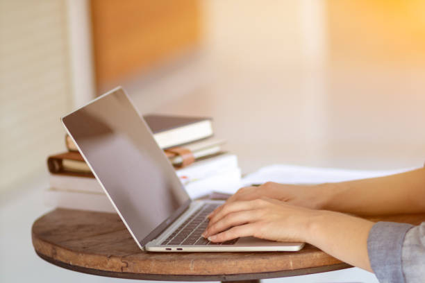 istock Young women work from home and use laptop computers to search for information and communicate with colleagues to work online. The concept of working from home with Notebook via online system. 1498468423