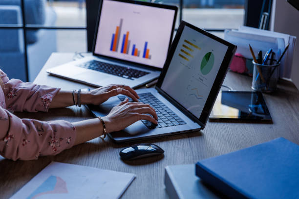 istock Businesswoman sitting at her desk, typing data on laptop when making a graph 1498468618