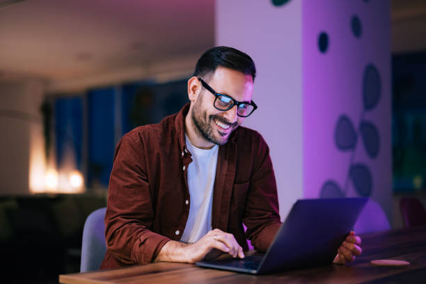 istock Smiling businessman taking a work break,  using a laptop, sitting at the home office. 1498472380