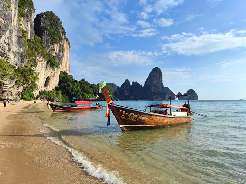 Long tail boats moored at the idyllic Ton Sai Beach, a secluded beach located on the southern coast of Thailand's Railay Peninsula, Krabi province.