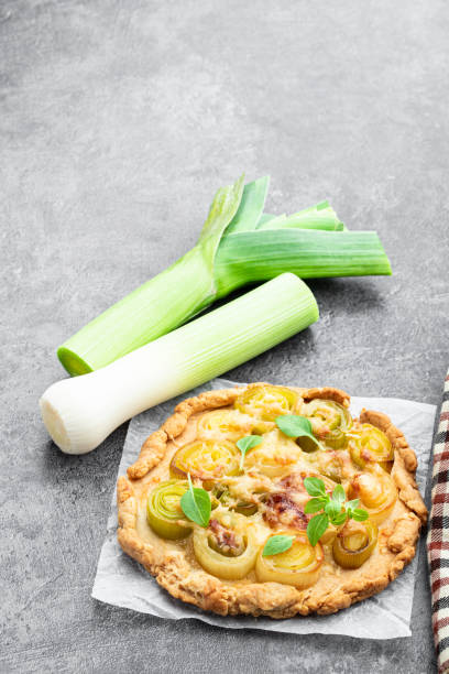 istock Leek and cheese tart on gray background 1498473376