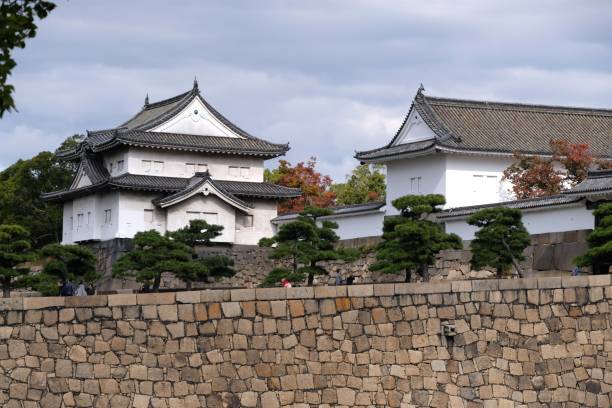 istock two small white buildings sitting on the side of a brick wall 1498473967