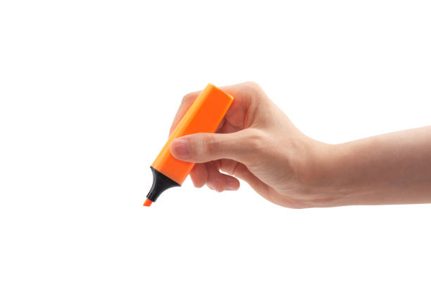 istock Close-up of a woman's hand holding a orange highlighter 1498474948