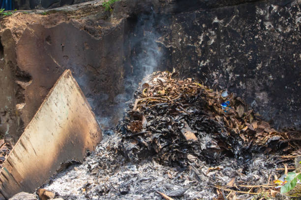 istock Burning dry leaves behind the house 1498475077