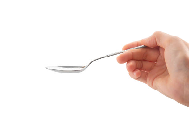 istock Female Hand Holding Spoon 1498475700