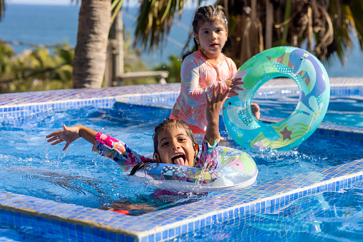 Happy girls in the pool with their lifeguards