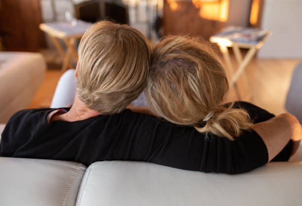 istock Mature lesbian couple relaxing on sofa 1498479751