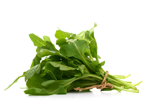 Arugula fresh heap leaf on white