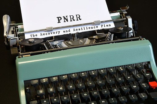 words 'PNRR The National Recovery and Resilience Plan' typed on vintage typewriter. The National Recovery and Resilience Plan is part of the Next Generation programme, that the European Union negotiated in response to the pandemic crisis Covid 19.