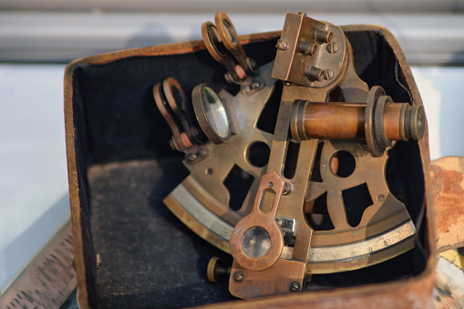 Antique ship sextant made of brass and glass. Old objects of the 18th century era, reenactment of events