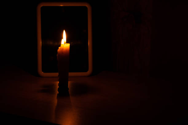 candle light in the reflection of a mirror standing on a table