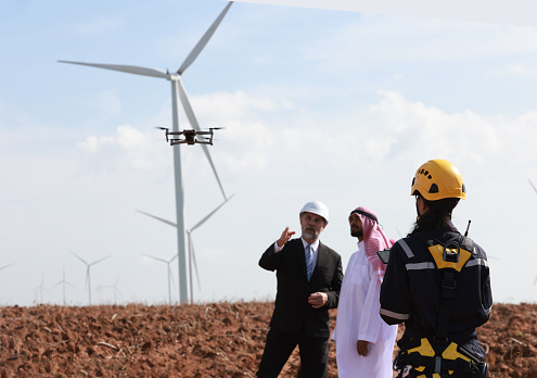 Wind Turbine Green energy megaproject  discussion with Arabs investor, Windmill farm's owner check the project with a drone