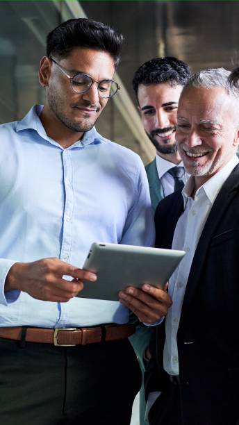 istock Young man using a digital tablet showing his project to his boss and colleagues at workplace. 1498493188