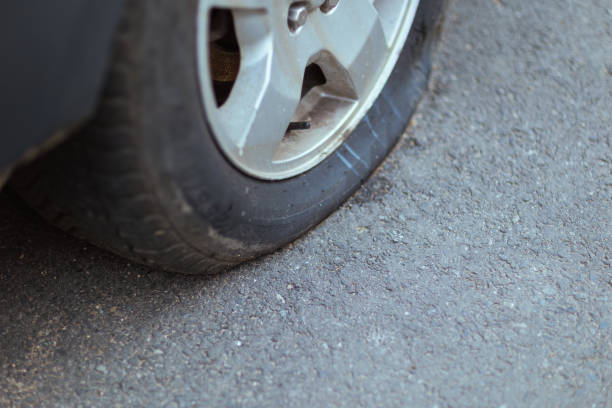 istock Closeup on car with flat tire in city 1498494287