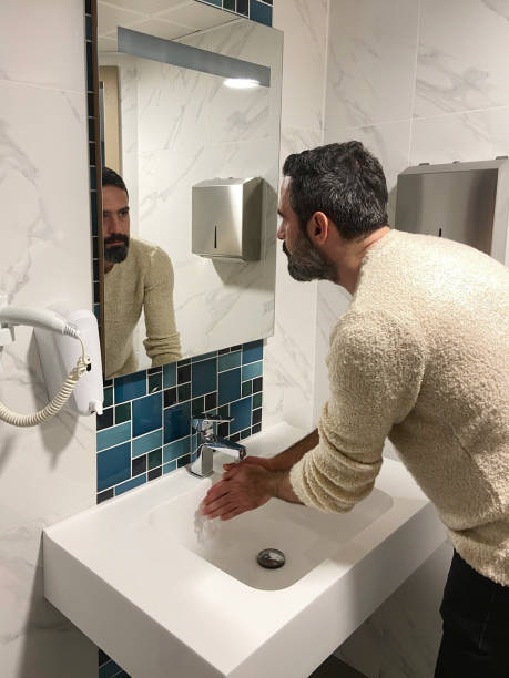 istock Man washing hands in the bathroom 1498494969