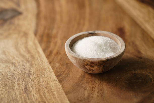 istock sugar in wood bowl on wooden table 1498496171