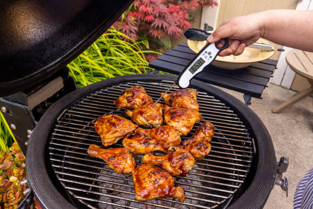 istock Woman Preparing and Barbecuing Chicken 1498497474