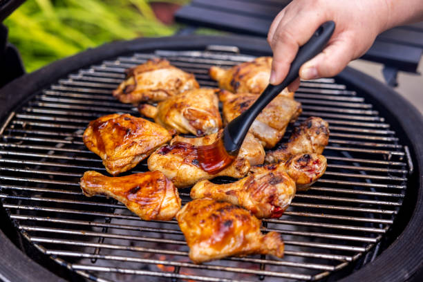 istock Woman Preparing and Barbecuing Chicken 1498497478