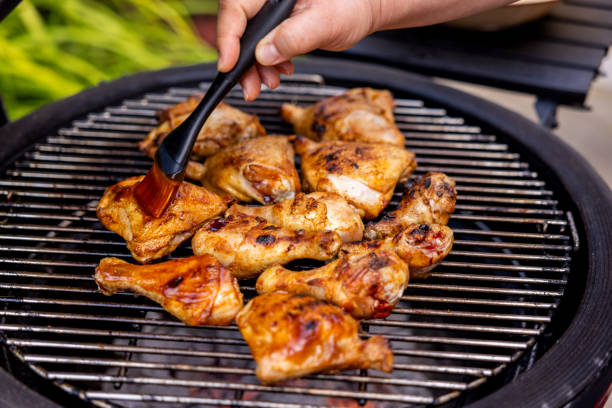 istock Woman Preparing and Barbecuing Chicken 1498497479