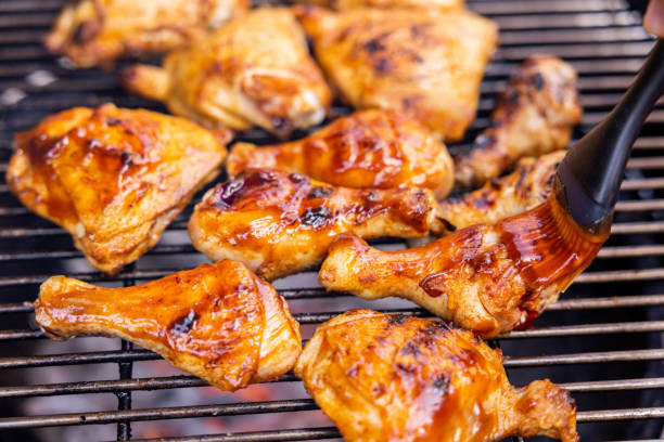 istock Woman Preparing and Barbecuing Chicken 1498497486