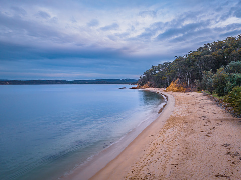 Overtones of blue sunset and twilight at Legges Beach, Twofold Bay in Eden on the South Coast of NSW, Australia.