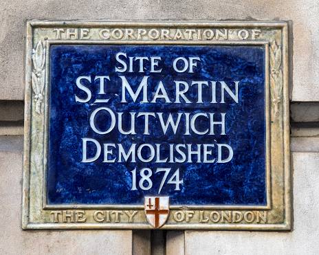 London, UK - March 2nd 2023: A blue plaque in the City of London, UK, marking the location where St. Martin Outwich was once located before it was demolished in 1874.