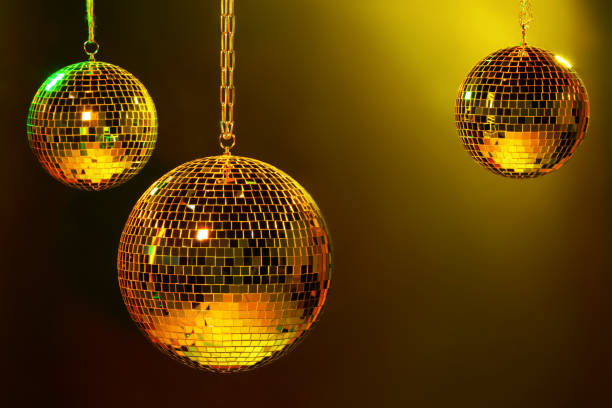 Shiny bright disco balls under color lights