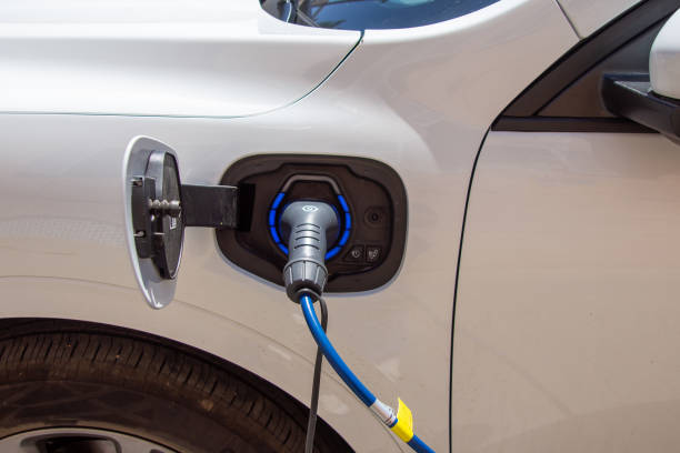 istock White electric car charging its battery. 1498499653